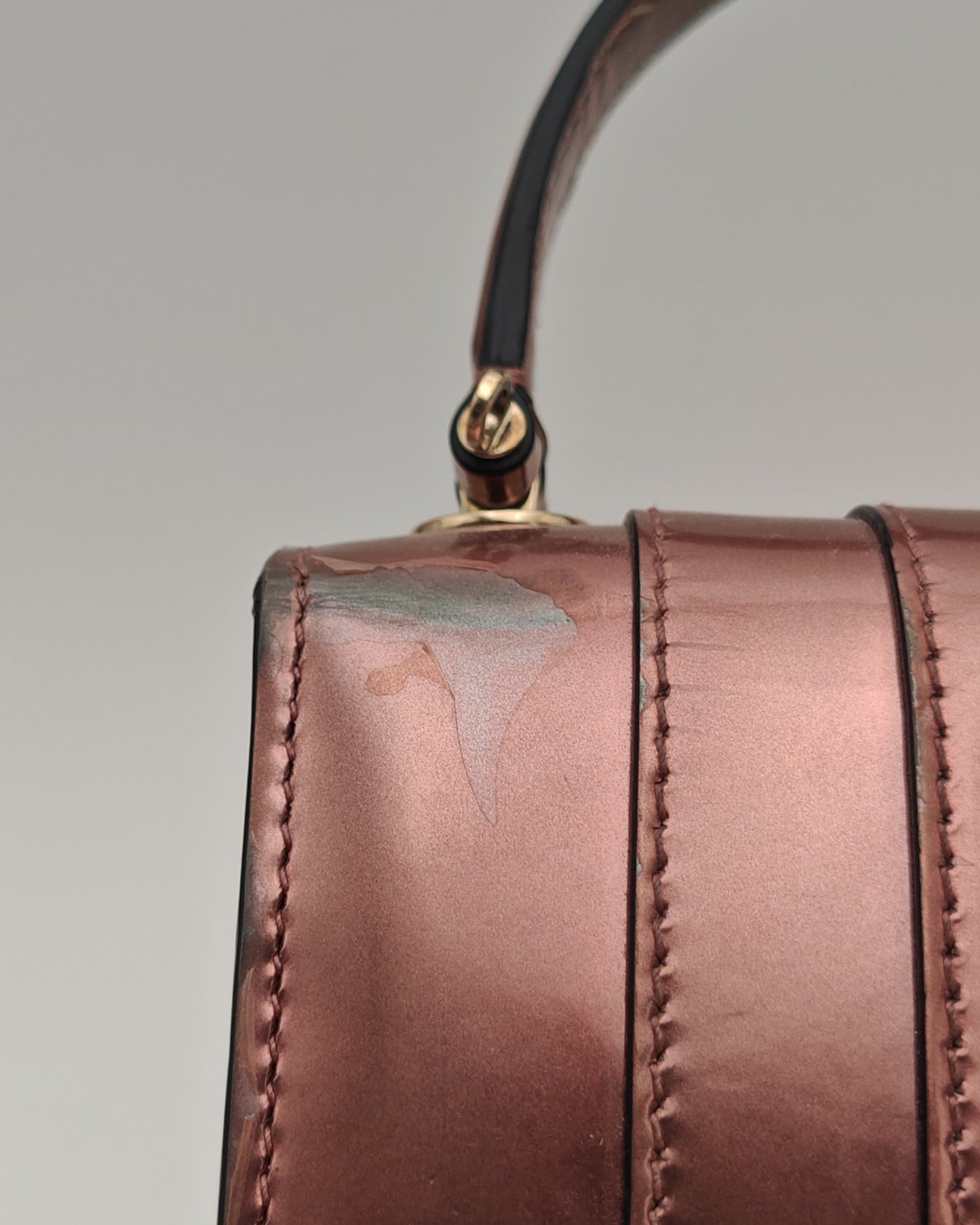 Bvlgari Serpenti Forever Top Handle Bag in Metallic Rose Leather with Gold Hardware.