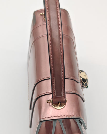 Bvlgari Serpenti Forever Top Handle Bag in Metallic Rose Leather with Gold Hardware.