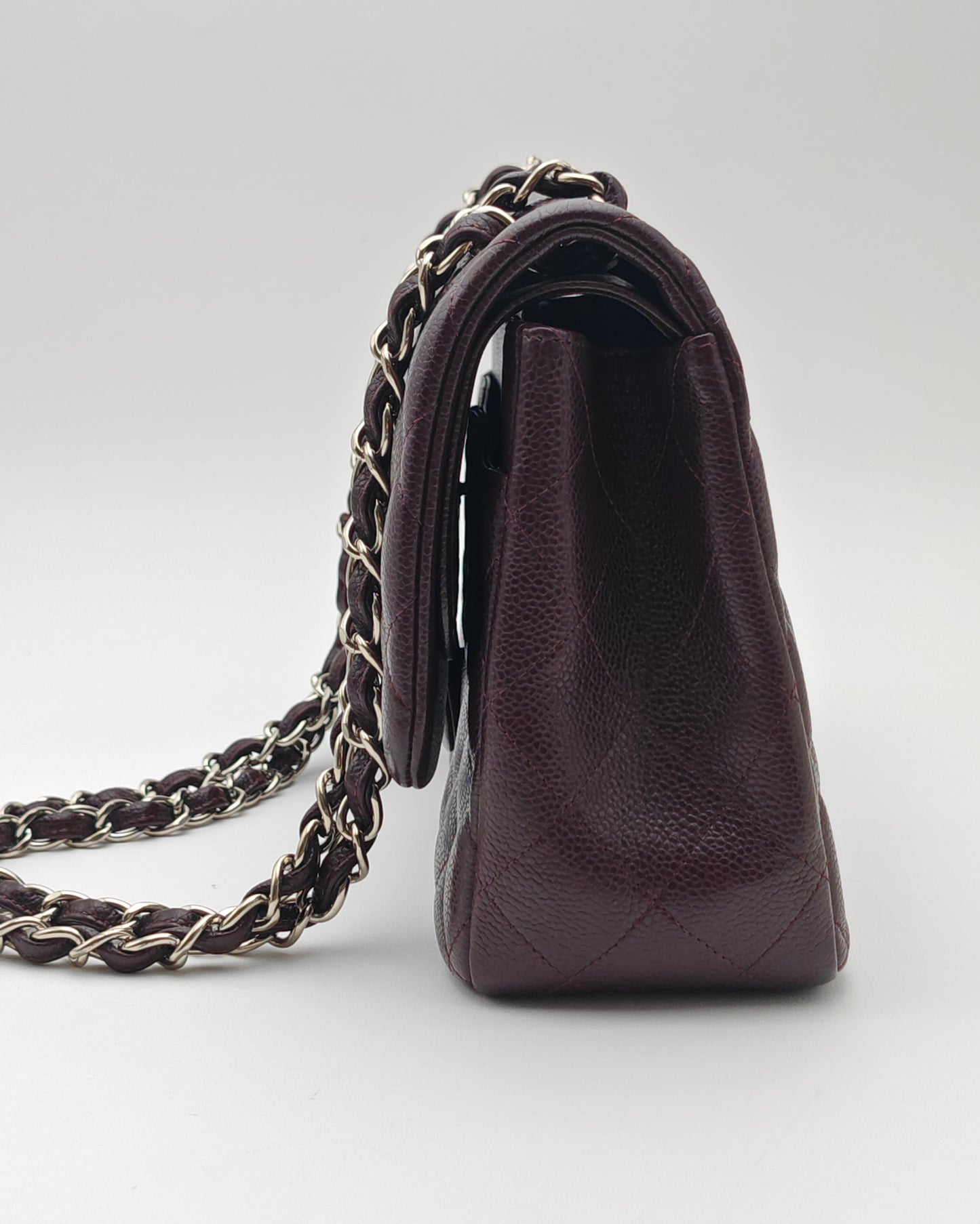 Chanel Classic Jumbo Double Flap Bag in Dark Burgundy Caviar Leather with Silver Hardware.