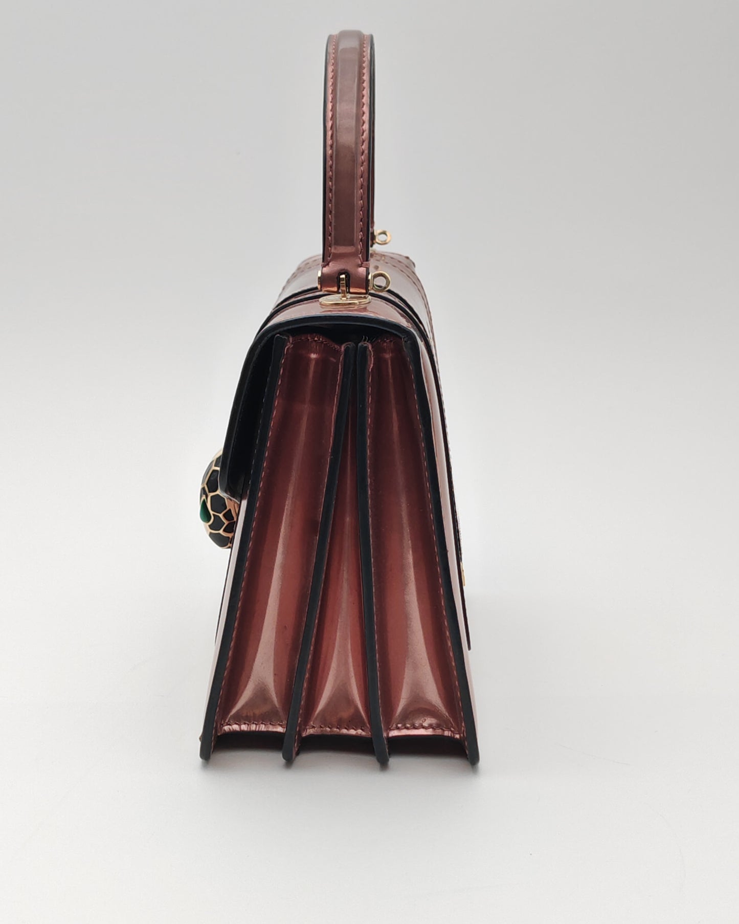 Bvlgari Serpenti Forever Top Handle Bag in Metallic Rose Leather with Gold Hardware.