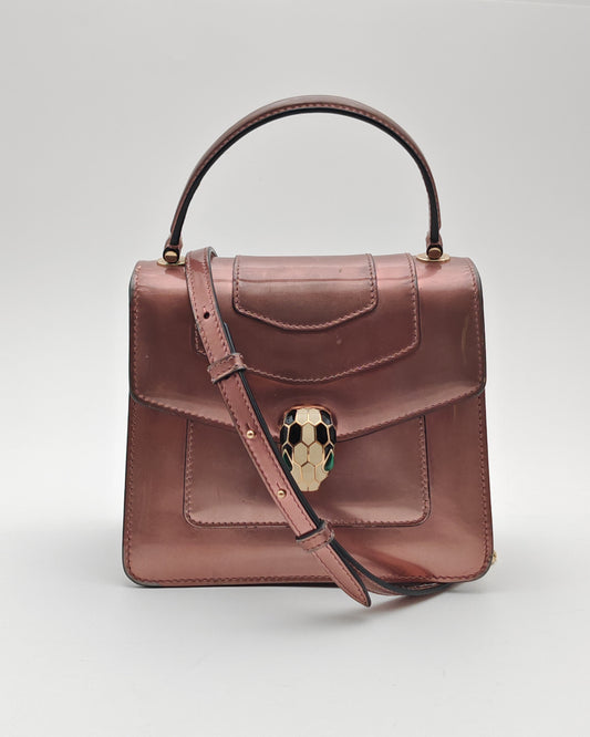 Bvlgari Serpenti Forever Top Handle Bag in Metallic Rose Leather with Gold Hardware.