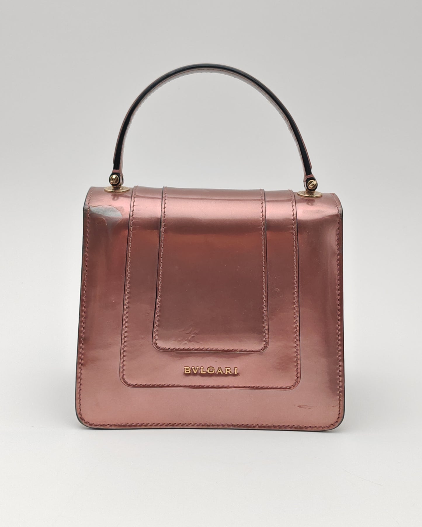 Bvlgari Serpenti Forever Top Handle Bag in Metallic Rose Leather with Gold Hardware.
