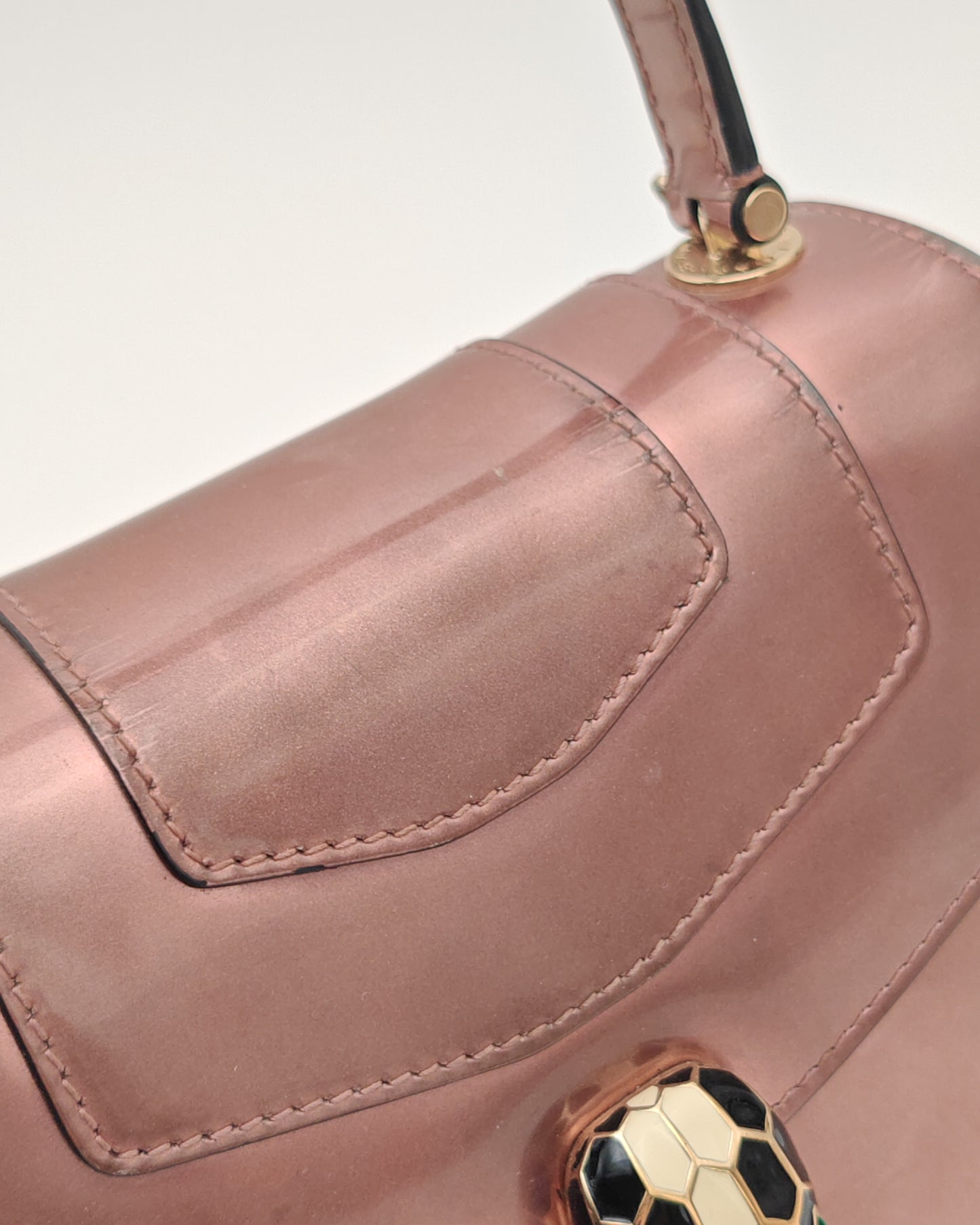 Bvlgari Serpenti Forever Top Handle Bag in Metallic Rose Leather with Gold Hardware.