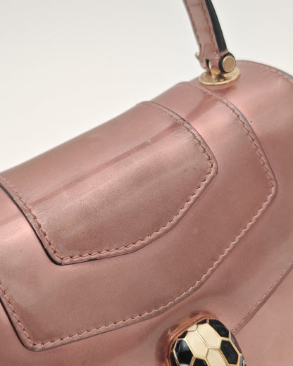 Bvlgari Serpenti Forever Top Handle Bag in Metallic Rose Leather with Gold Hardware.